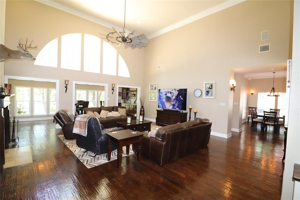 2642 Huddleston Road Sunset, TX 76270 - Photo 10 of 40 a living room with fireplace furniture and a chandelier