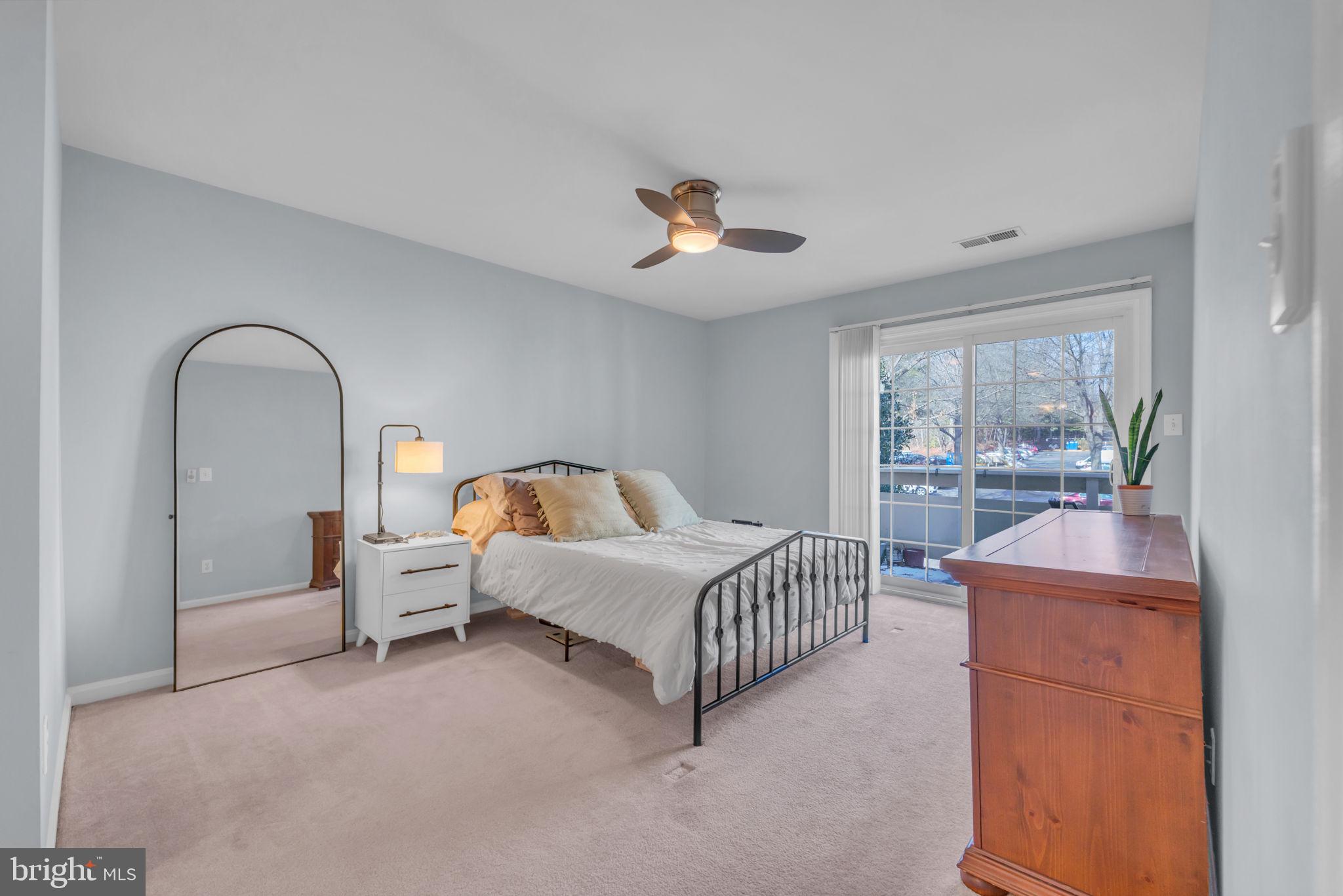 2233 Lovedale Lane, Unit L Reston, VA 20191 - Photo 12 of 18 a bed room with a bed and a chandelier