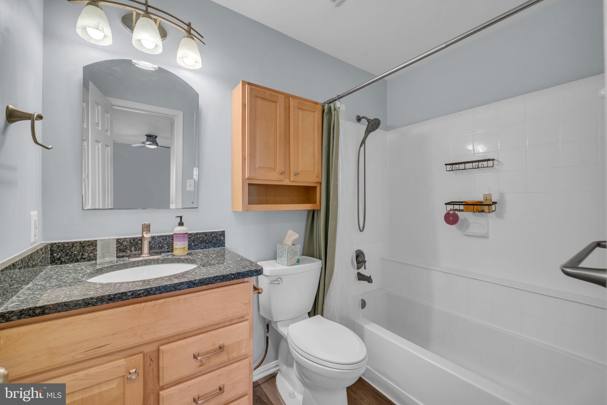 2233 Lovedale Lane, Unit L Reston, VA 20191 - Photo 14 of 18 a bathroom with a granite countertop sink toilet and shower