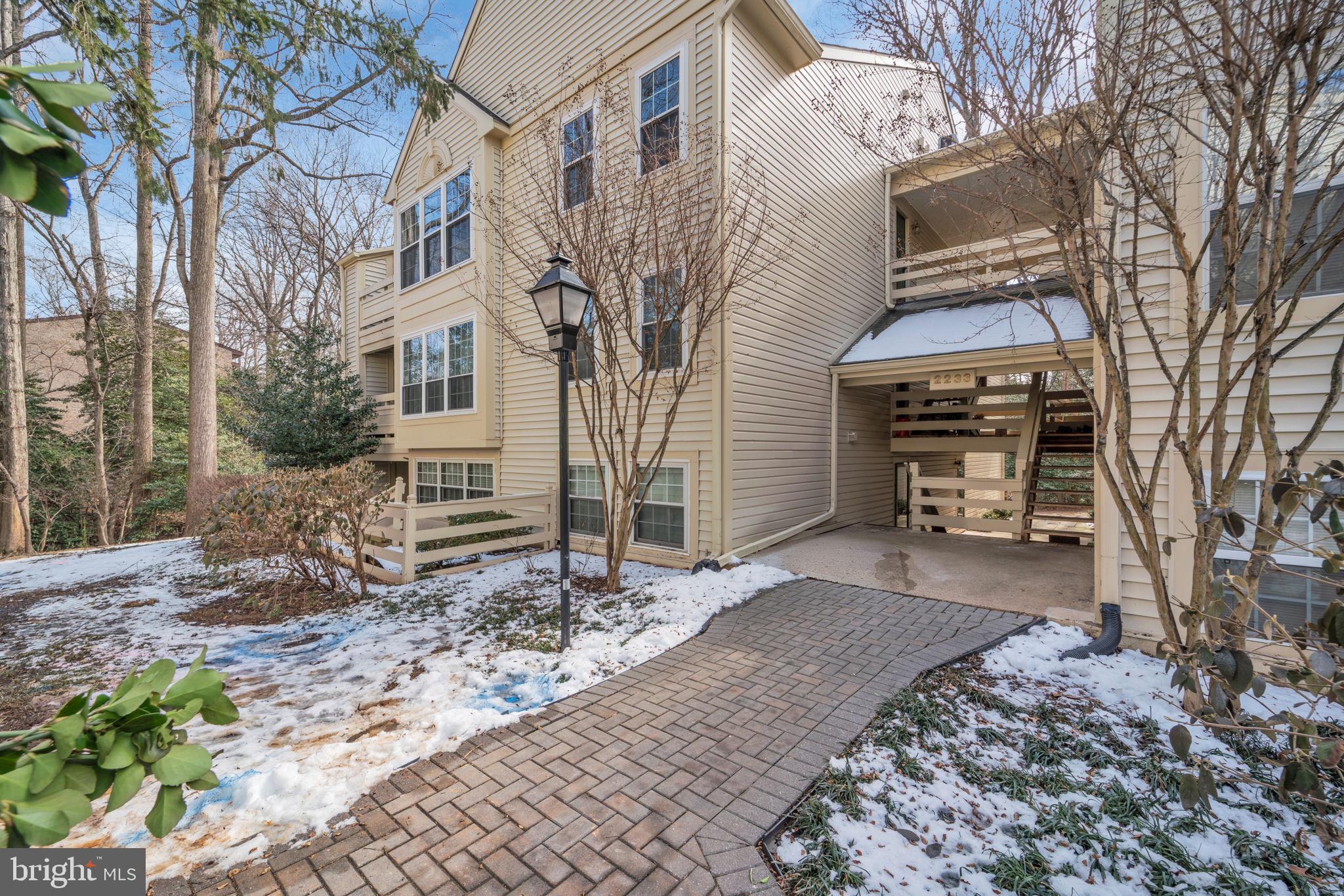 2233 Lovedale Lane, Unit L Reston, VA 20191 - Photo 2 of 18 a front view of a house with a yard