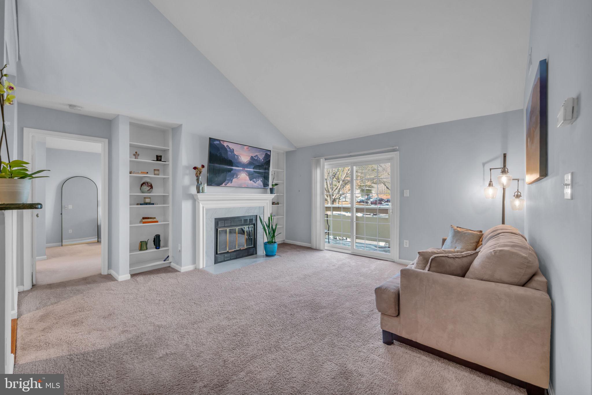 2233 Lovedale Lane, Unit L Reston, VA 20191 - Photo 7 of 18 a living room with furniture and a fireplace