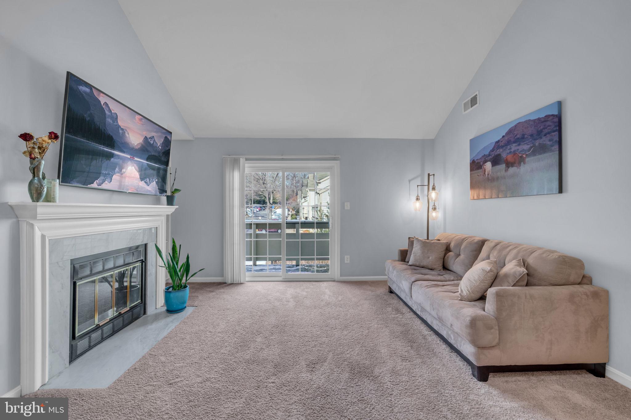 2233 Lovedale Lane, Unit L Reston, VA 20191 - Photo 8 of 18 a living room with furniture and a fireplace