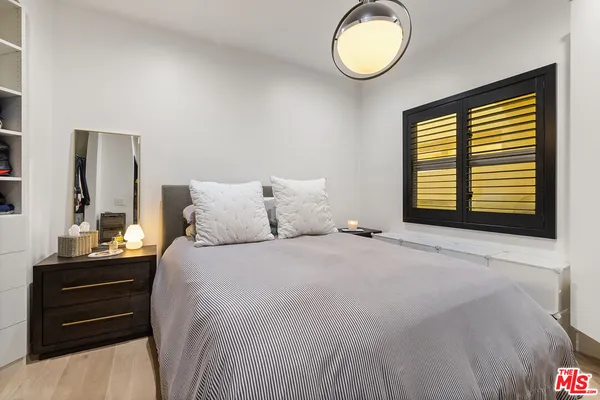 a bedroom with a bed and a television