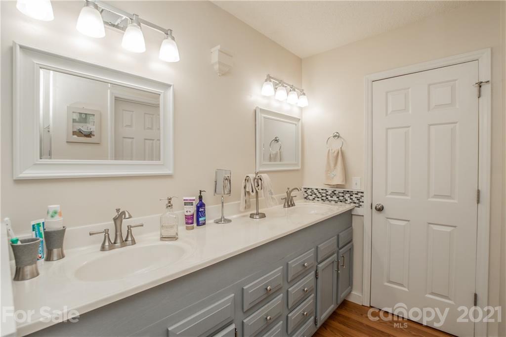 1360 Mistletoe Ridge Place Northwest Concord, NC 28027 - Photo 22 of 38 a bathroom with a sink double vanity and a mirror
