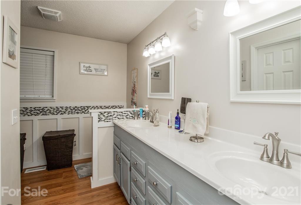 1360 Mistletoe Ridge Place Northwest Concord, NC 28027 - Photo 23 of 38 a bathroom with a double vanity sink and a mirror