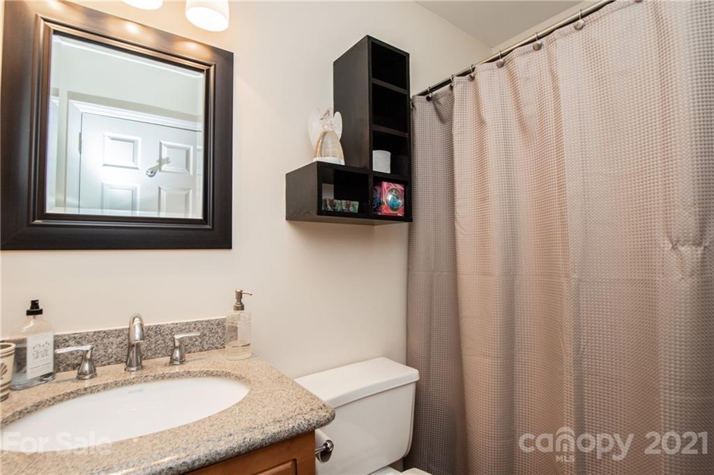 1360 Mistletoe Ridge Place Northwest Concord, NC 28027 - Photo 28 of 38 a bathroom with a granite countertop sink and a mirror