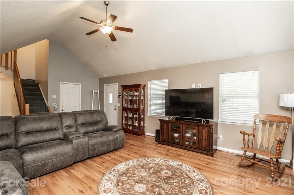 1360 Mistletoe Ridge Place Northwest Concord, NC 28027 - Photo 6 of 38 a living room with furniture and a flat screen tv