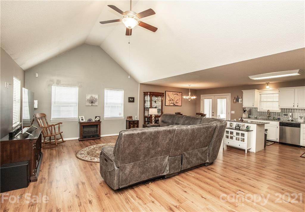 1360 Mistletoe Ridge Place Northwest Concord, NC 28027 - Photo 7 of 38 a living room with furniture and a wooden floor