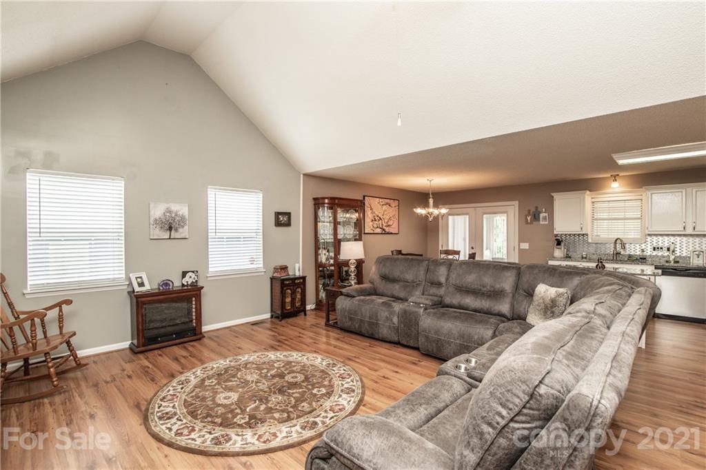 1360 Mistletoe Ridge Place Northwest Concord, NC 28027 - Photo 8 of 38 a living room with furniture and a wooden floor