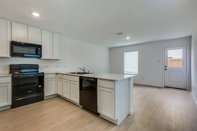 a kitchen with granite countertop a stove and a sink