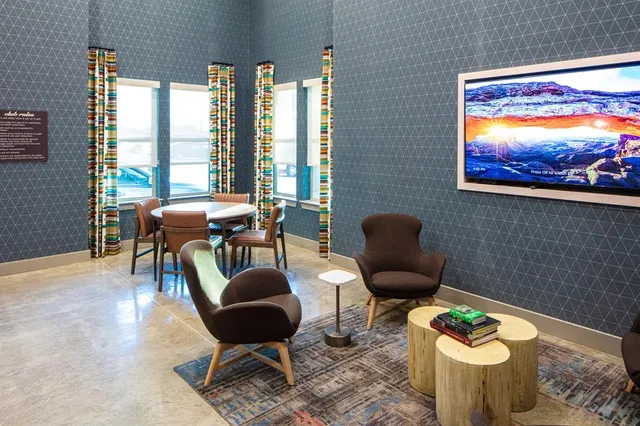 a living room with furniture and a floor to ceiling window
