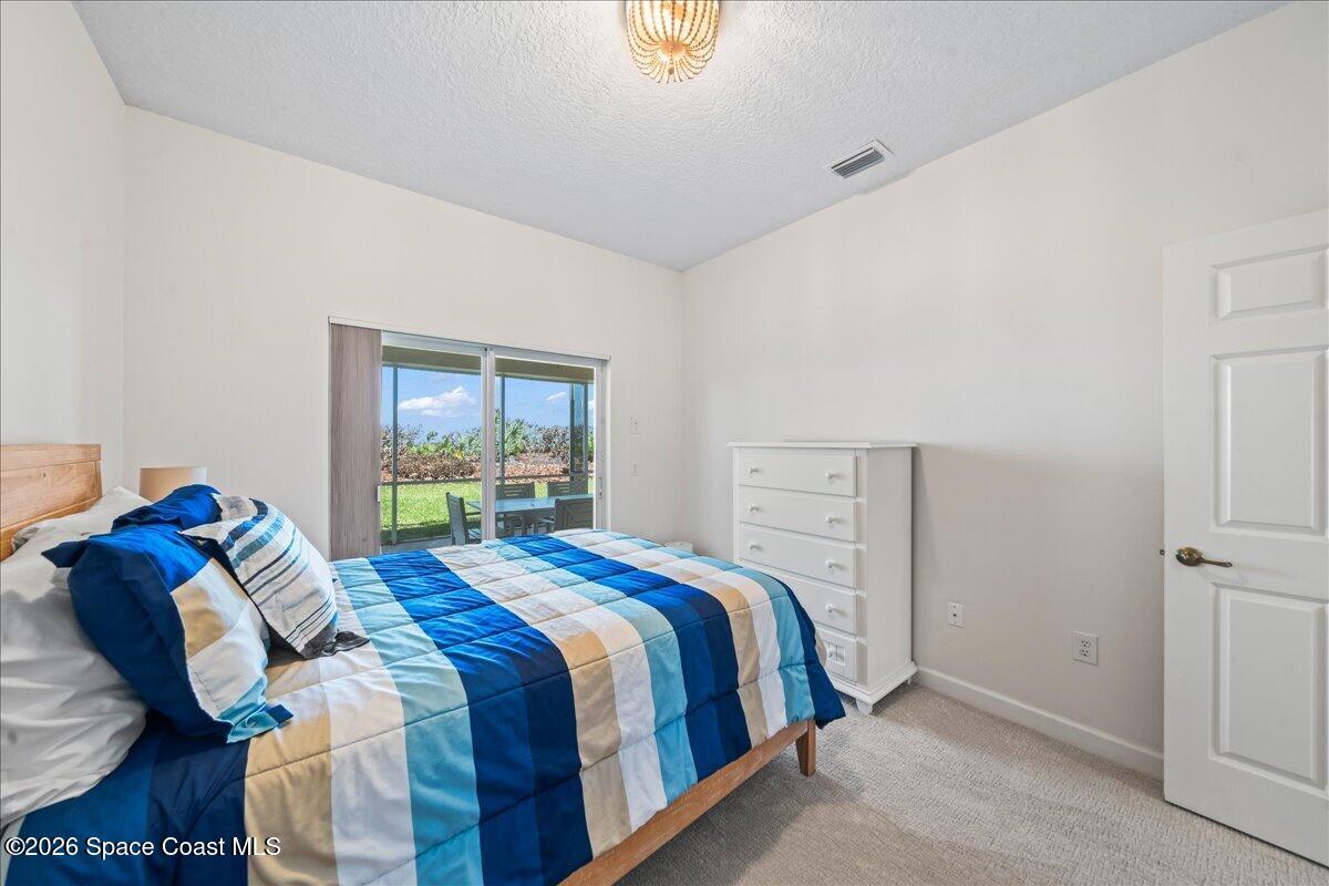7585 South Hwy A1A Melbourne Beach, FL 32951 - Photo 25 of 45 a bedroom with a bed and a window