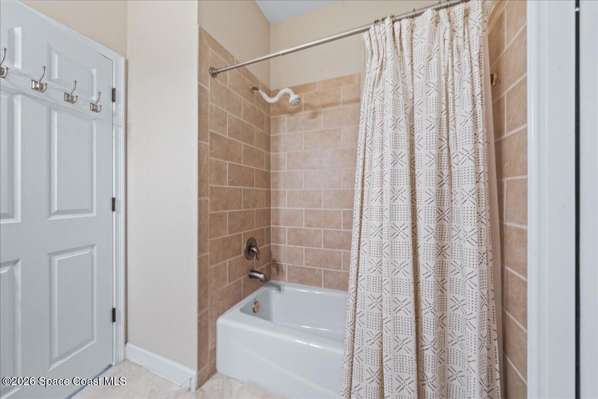 7585 South Hwy A1A Melbourne Beach, FL 32951 - Photo 27 of 45 a bathroom with a shower and a tub