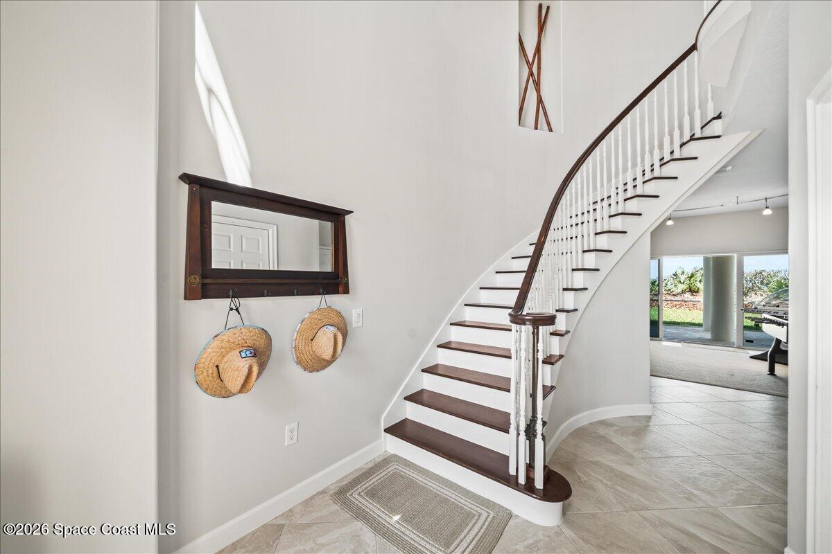 7585 South Hwy A1A Melbourne Beach, FL 32951 - Photo 4 of 45 a view of entryway with wooden floor and windows