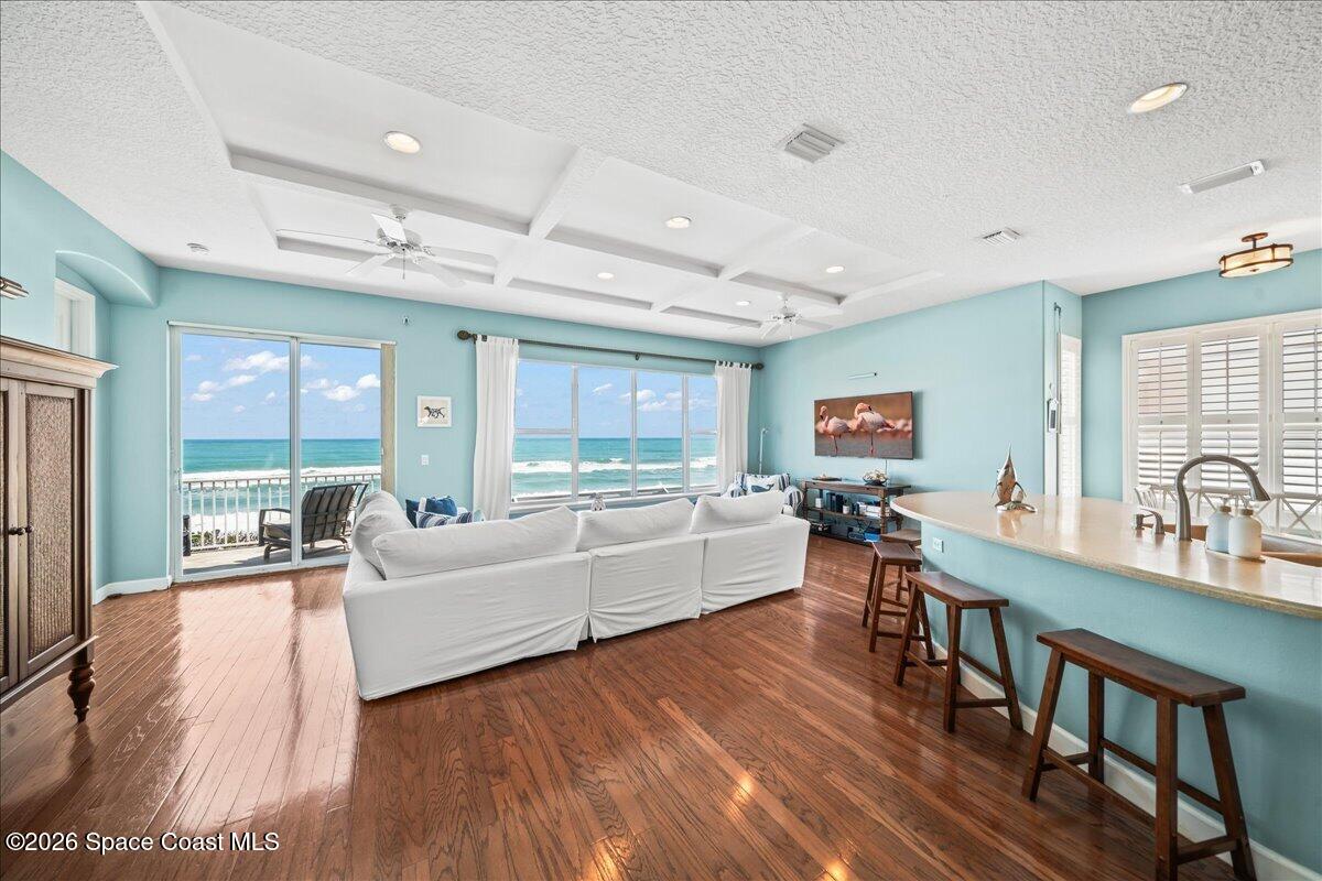 7585 South Hwy A1A Melbourne Beach, FL 32951 - Photo 7 of 45 a living room with furniture and a large window