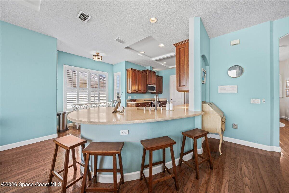 7585 South Hwy A1A Melbourne Beach, FL 32951 - Photo 10 of 45 a dining room with furniture and wooden floor
