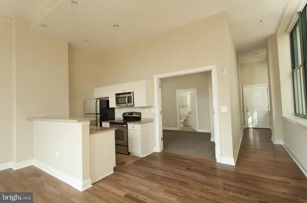 a view of a kitchen with a sink dishwasher and a refrigerator