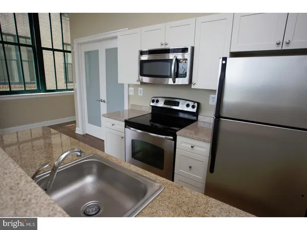 a kitchen with a refrigerator stove and microwave