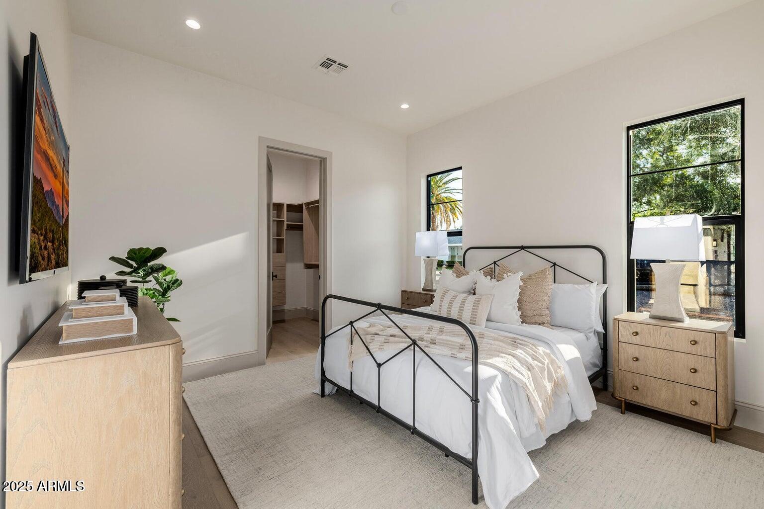 3301 East Elm Street Phoenix, AZ 85018 - Photo 18 of 36 a bedroom with a bed and a potted plant