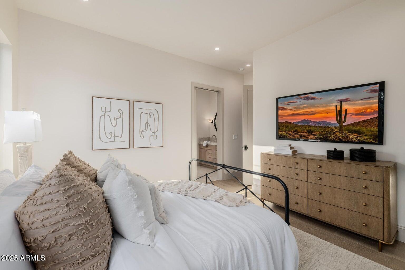 3301 East Elm Street Phoenix, AZ 85018 - Photo 19 of 36 a bedroom with a bed and a flat screen tv