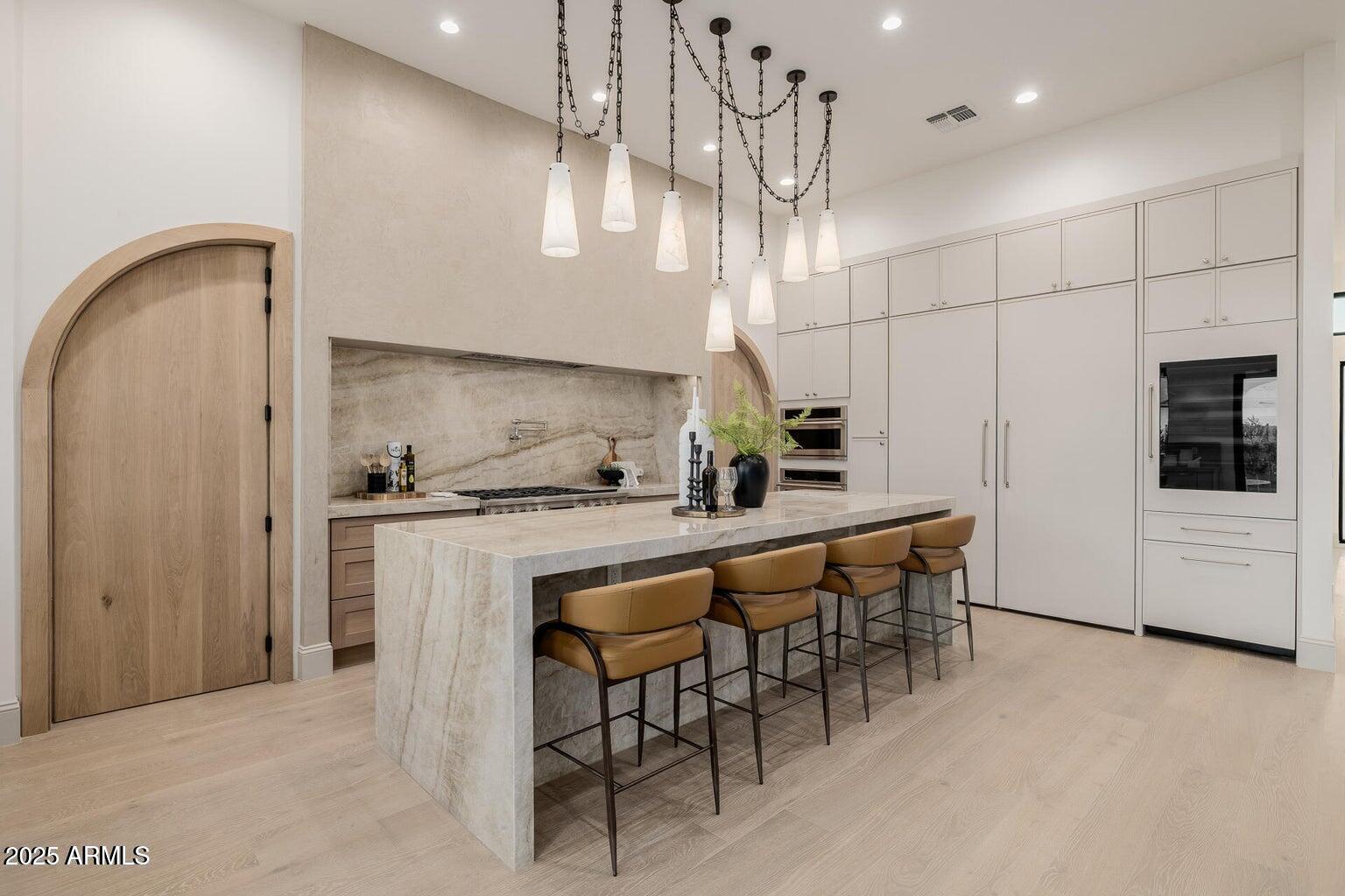 3301 East Elm Street Phoenix, AZ 85018 - Photo 7 of 36 a kitchen with stainless steel appliances a table chairs and entryway