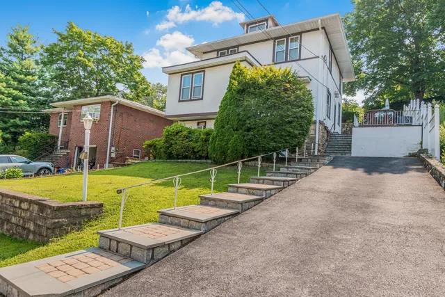 a view of a house with backyard and swimming pool