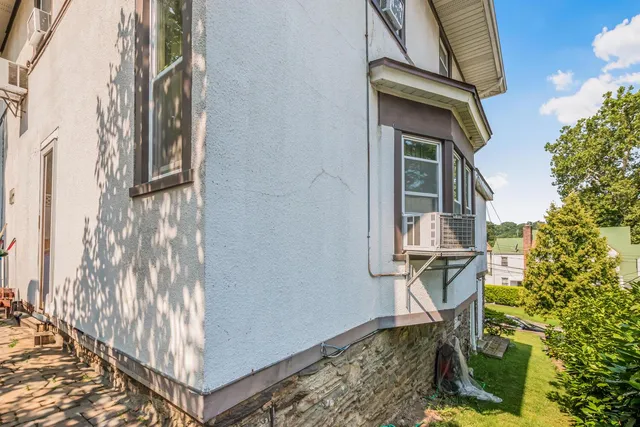 a front view of a house with swimming pool and garden