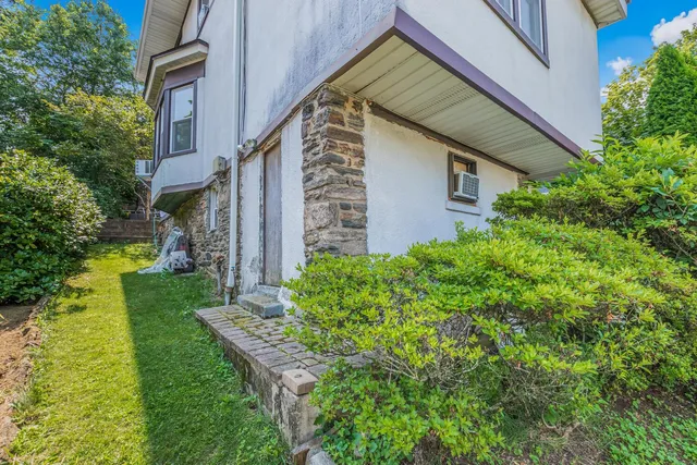 a patio with table and chairs and potted plants