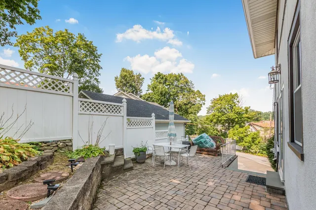 a view of a dining room and livingroom with furniture wooden floor and a rug