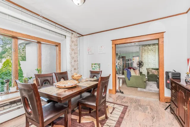 a living room with furniture a fireplace and a floor to ceiling window