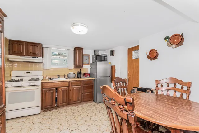 a bedroom with furniture a fireplace and a flat screen tv
