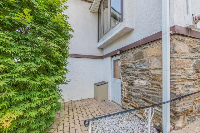 a view of a porch with a bench and potted plants