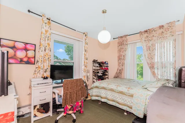 a view of a hallway with wooden floor and bathroom