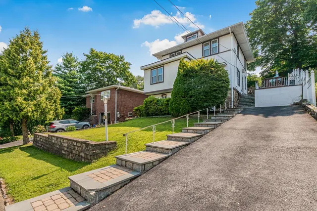 a view of a house with swimming pool and a yard