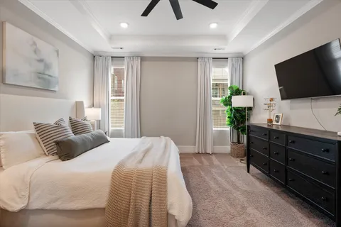 a bedroom with a bed and a flat screen television