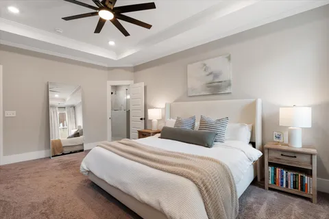 a bedroom with a large bed and a chandelier