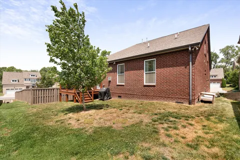a view of a backyard with wooden fence