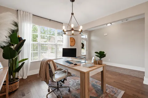 a workspace with furniture and a chandelier