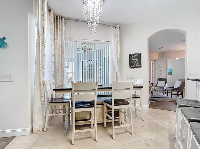 a view of a dining room with furniture and chandelier