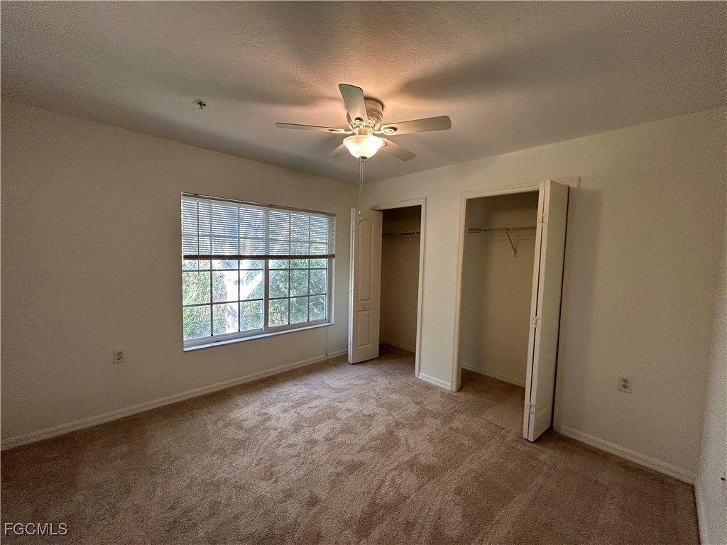 9410 Ivy Brook Run, Unit 206 Fort Myers, FL 33913 - Photo 11 of 16 a view of a livingroom with a ceiling fan and window