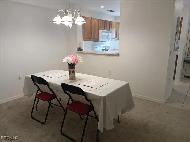 a view of a dining room with furniture and chandelier
