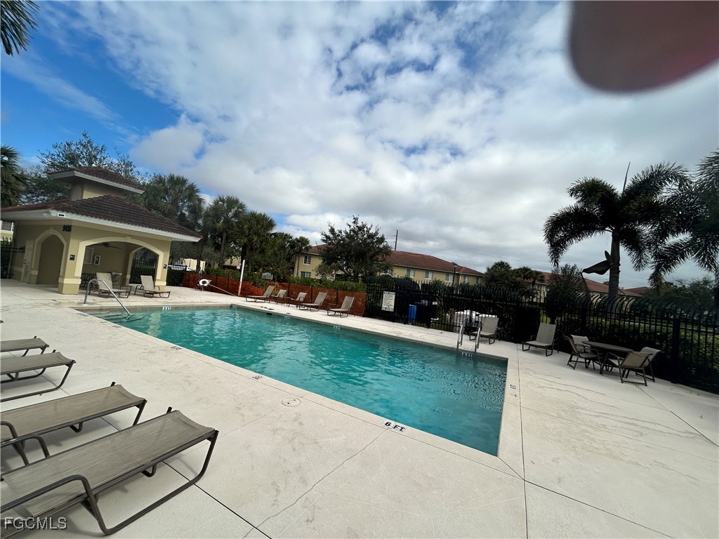 9410 Ivy Brook Run, Unit 206 Fort Myers, FL 33913 - Photo 2 of 16 a view of house with swimming pool outdoor seating