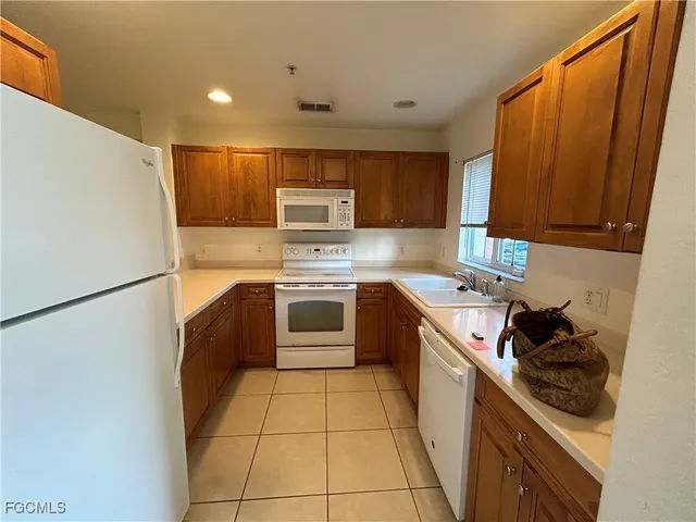 a kitchen with a sink a stove and refrigerator