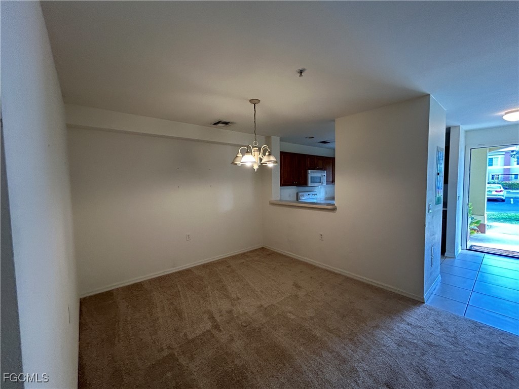 9410 Ivy Brook Run, Unit 206 Fort Myers, FL 33913 - Photo 6 of 16 an empty room with wooden floor and windows