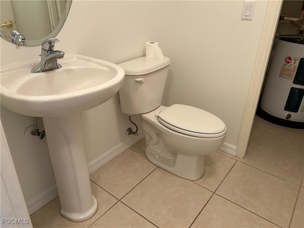 9410 Ivy Brook Run, Unit 206 Fort Myers, FL 33913 - Photo 8 of 16 a bathroom with a sink toilet and a mirror