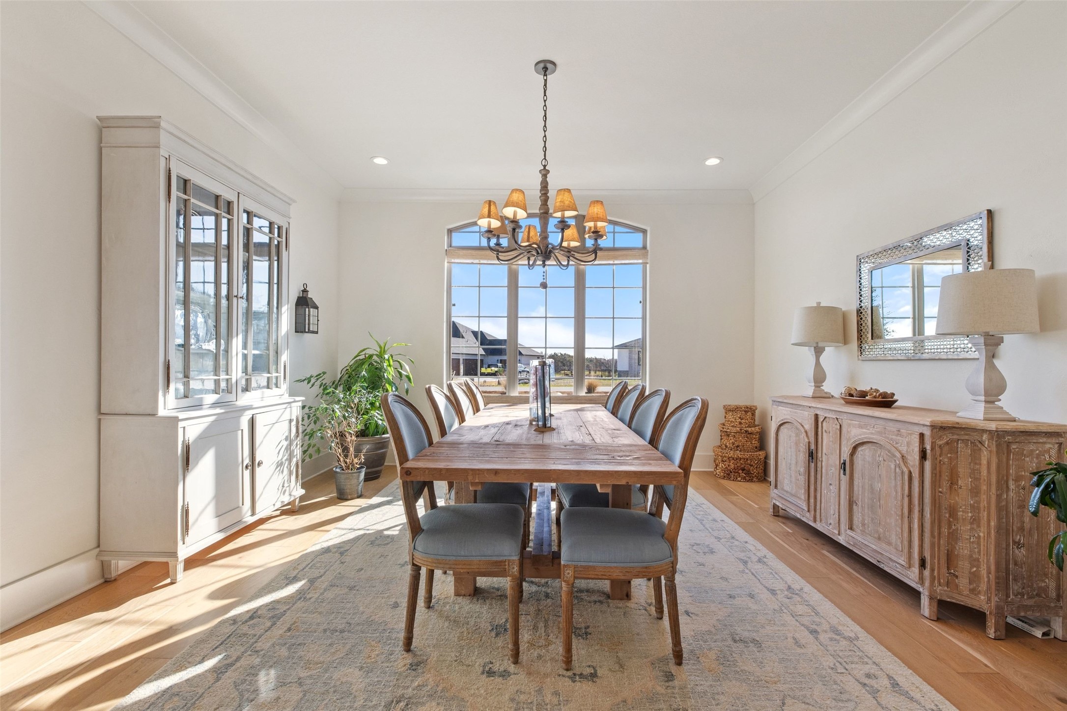 105 Deer Valley Road Georgetown, TX 78628 - Photo 11 of 40 Dining space with suspended lighting, ornamental molding, light wood-style flooring, and plenty of natural light
