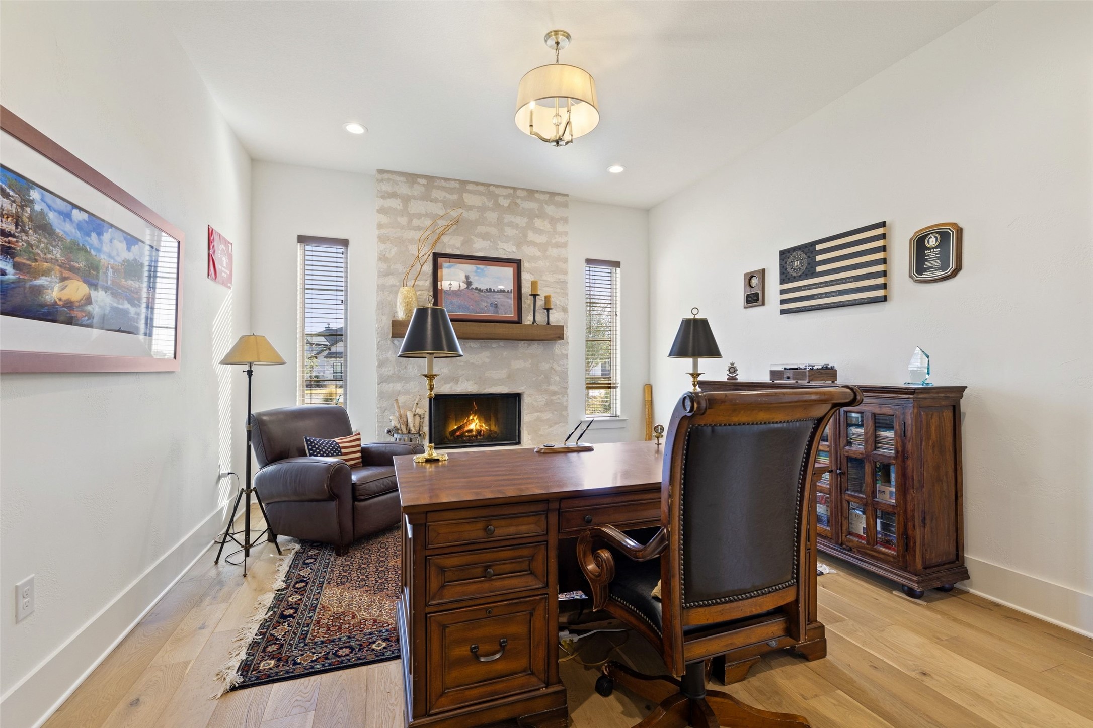 105 Deer Valley Road Georgetown, TX 78628 - Photo 12 of 40 Office space with light wood-style flooring, a stone fireplace, and recessed lighting
