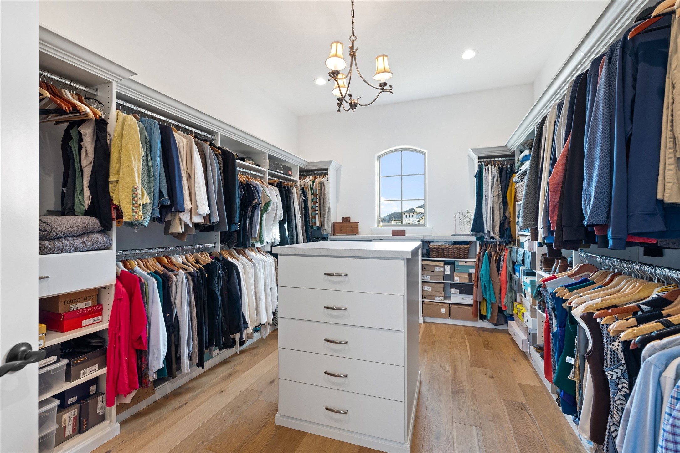 105 Deer Valley Road Georgetown, TX 78628 - Photo 18 of 40 Walk in closet featuring light wood-style flooring and hanging lights