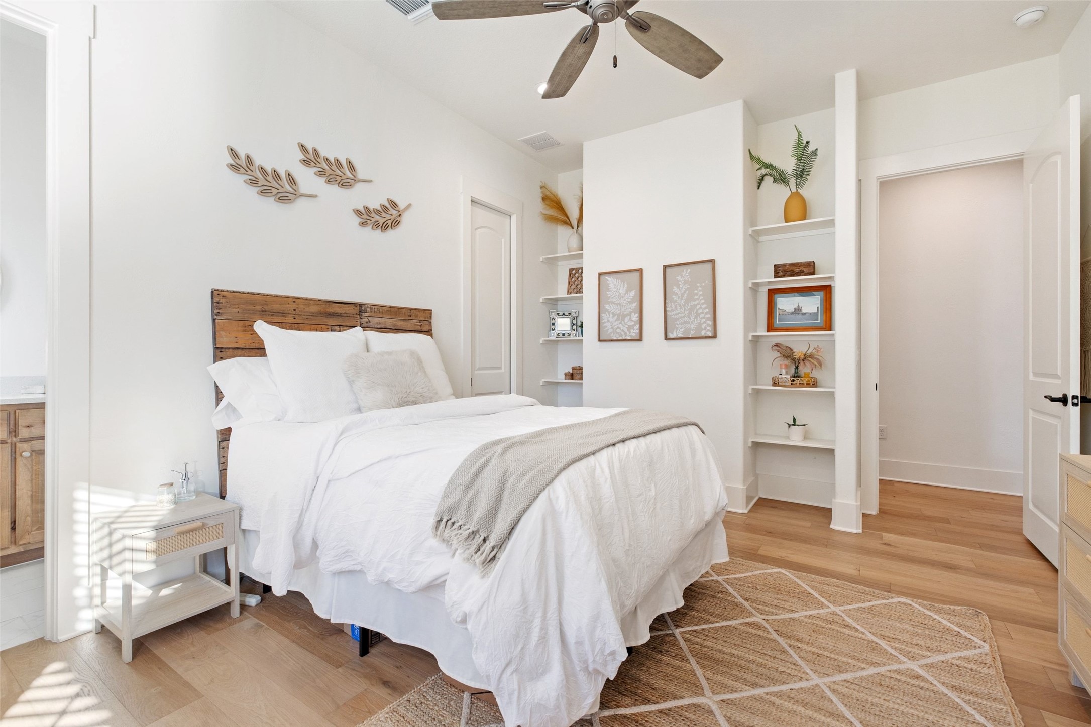 105 Deer Valley Road Georgetown, TX 78628 - Photo 30 of 40 Bedroom with light wood-type flooring, ensuite bathroom, and ceiling fan