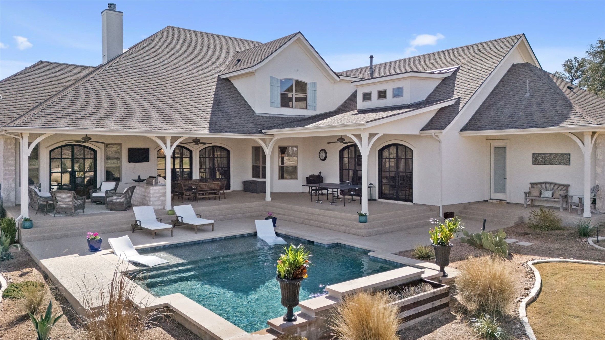 105 Deer Valley Road Georgetown, TX 78628 - Photo 3 of 40 Rear view of house featuring a patio, stucco siding, and roof with shingles